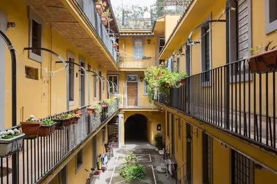 an alley between two buildings with balconies and plants at Campo 13 Holiday Apartment in Rome