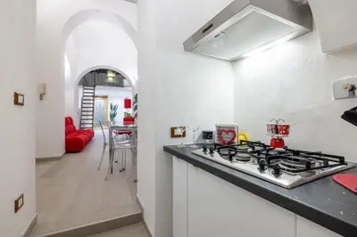 a kitchen with a stove top oven next to a counter at Lovely studio Apartment - Capocci in Rome