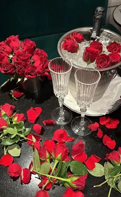 a table topped with red roses and wine glasses at CadensPlace - Overlooking Piazza Navona by dbalconycollection in Rome