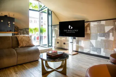 a living room with a couch and a tv at CadensPlace - Overlooking Piazza Navona by dbalconycollection in Rome