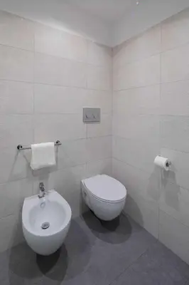 a bathroom with a toilet and a bidet at Via Vespasiano Private Apartment in Rome