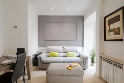 a living room with a couch and a table at Via Vespasiano Private Apartment in Rome