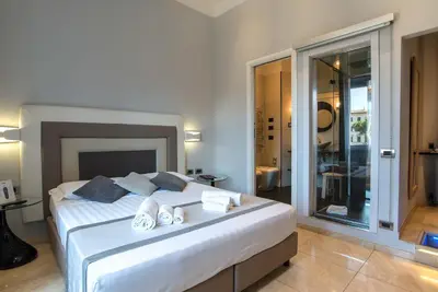 a bedroom with a large bed and a bathroom at Pantheon Caesar Relais in Rome