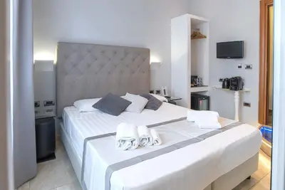 a bedroom with a large white bed with towels on it at Pantheon Caesar Relais in Rome