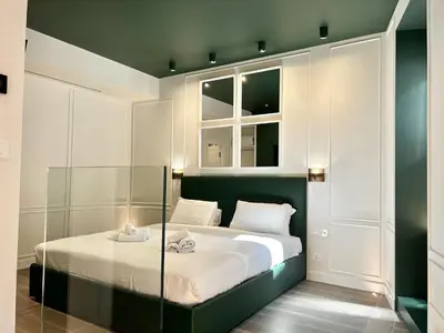 a bedroom with a bed and two windows at PRIVATE LUXURY FONTANA DI TREVI in Rome