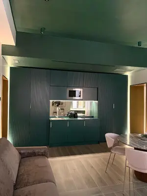 a living room with a couch and a kitchen at PRIVATE LUXURY FONTANA DI TREVI in Rome