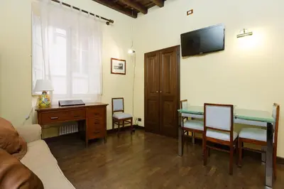 a bathroom with a sink and a toilet and a mirror at Cozy apartment in Rome