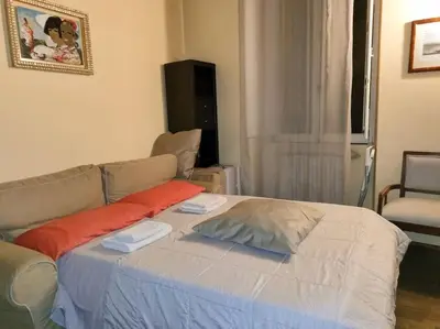 a bed in a living room with a couch at Cozy apartment in Rome
