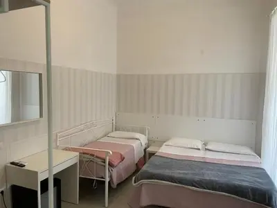 a bedroom with two beds and a colorful mural at Hotel Giada Roma in Rome