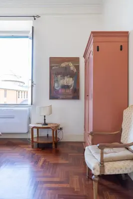 a living room with a chair and a table at Casa di Amici alla Garbatella in Rome