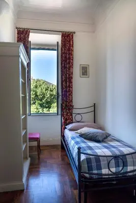 a bedroom with a bed and a window at Casa di Amici alla Garbatella in Rome