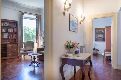 a living room with a table and a chair at Casa di Amici alla Garbatella in Rome