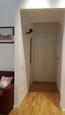 an empty living room with a couch and a door at La Casetta di Monteverde in Rome