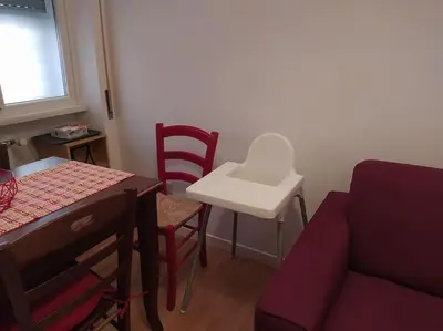 a living room with a couch and a table and chairs at La Casetta di Monteverde in Rome
