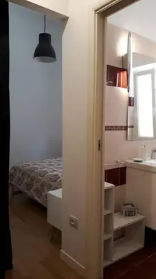 a bathroom with a sink and a bedroom with a bed at La Casetta di Monteverde in Rome