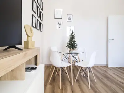 a dining room with a glass table and white chairs at Home Holiday Rome - Basilica San Pietro in Rome