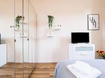 a bedroom with a glass shower and a tv at Home Holiday Rome - Basilica San Pietro in Rome
