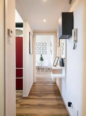 a hallway leading to a living room with a table at Home Holiday Rome - Basilica San Pietro in Rome