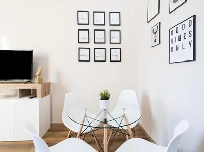 a dining room with a glass table and white chairs at Home Holiday Rome - Basilica San Pietro in Rome