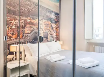 a bedroom with a bed with a painting on the wall at Home Holiday Rome - Basilica San Pietro in Rome