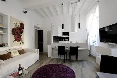 a white living room with a couch and a table at Antiche Residenze Romane Pantheon in Rome