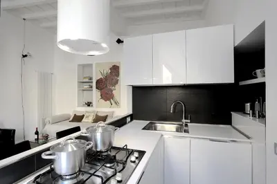 a white kitchen with two pots on the stove at Antiche Residenze Romane Pantheon in Rome