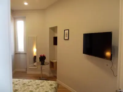 a living room with a flat screen tv on a wall at Bonavista inn in Rome