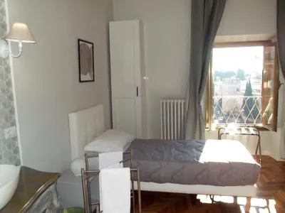 a small room with a bed and a window at Bonavista inn in Rome