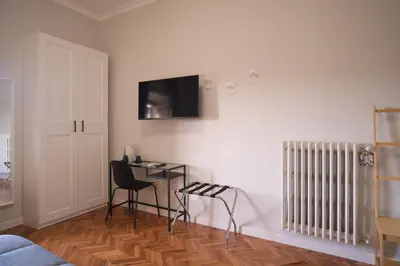 a room with a desk and a tv on the wall at Bonavista inn in Rome