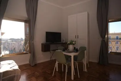 a room with a table and chairs and a television at Bonavista inn in Rome