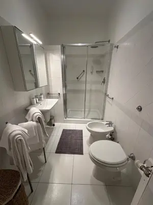 a bathroom with a shower and a toilet and a sink at House of the Sun in Trastevere in Rome