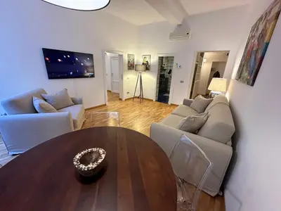a living room with a couch and a table at House of the Sun in Trastevere in Rome