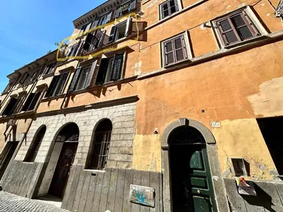a building with a green door in front of it at House of the Sun in Trastevere in Rome