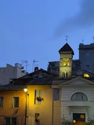 a building with a clock tower on top of it at House of the Sun in Trastevere in Rome