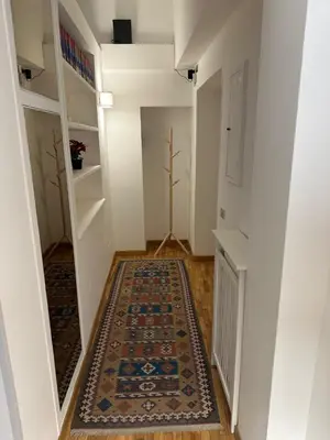 a hallway with a rug on the floor at House of the Sun in Trastevere in Rome
