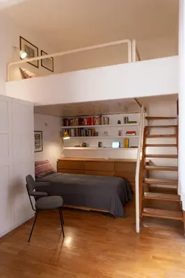 a bedroom with a bunk bed and a chair at Gallery Apartment, Near The Vatican in Rome