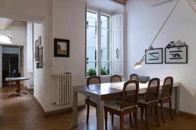 a dining room with a table and chairs at Gallery Apartment, Near The Vatican in Rome