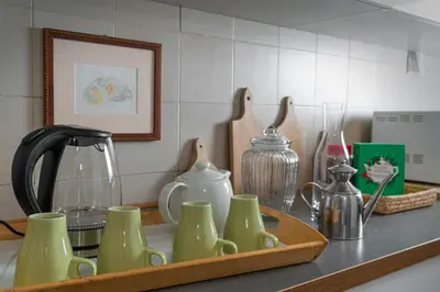 a kitchen counter with a tray of cups and utensils at Gallery Apartment, Near The Vatican in Rome