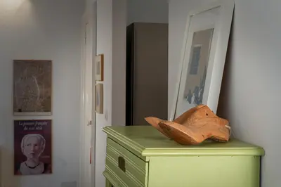 a wooden shoe sitting on top of a green dresser at Gallery Apartment, Near The Vatican in Rome