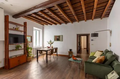 a living room with a green couch and a table at iFlat Classic And Contemporary Home in Rome
