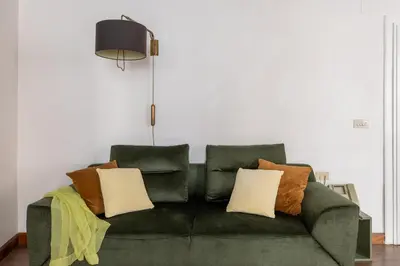 a green couch with pillows in a living room at iFlat Classic And Contemporary Home in Rome