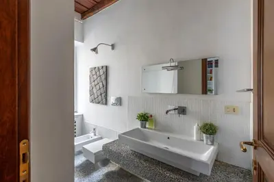 a white bathroom with two sinks and a large tub at iFlat Classic And Contemporary Home in Rome