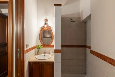 a bathroom with a sink and a mirror at iFlat Classic And Contemporary Home in Rome