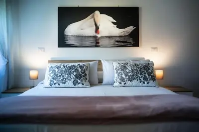 a bedroom with a white swan in the water at Family house in Rome