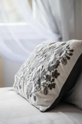 a black and white pillow sitting on a bed at Family house in Rome