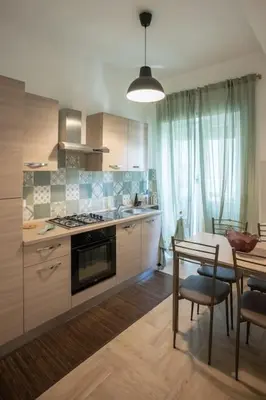 a kitchen with a table and a stove top oven at Family house in Rome