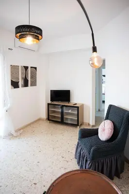 a living room with a couch and a tv at Family house in Rome