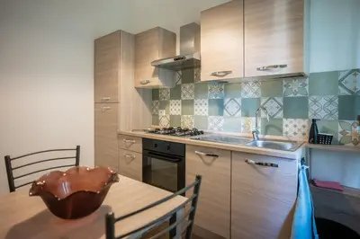 a kitchen with a table and a sink and a stove at Family house in Rome
