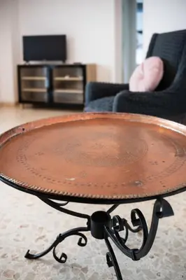a wooden coffee table in a living room with a tv at Family house in Rome