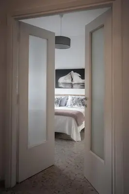 an open door to a bedroom with a bed at Family house in Rome